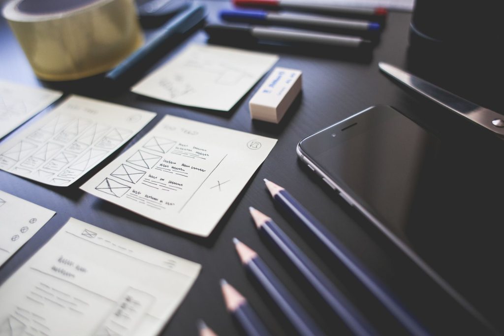 Interface sketches, pencils and a tablet on a designer desk