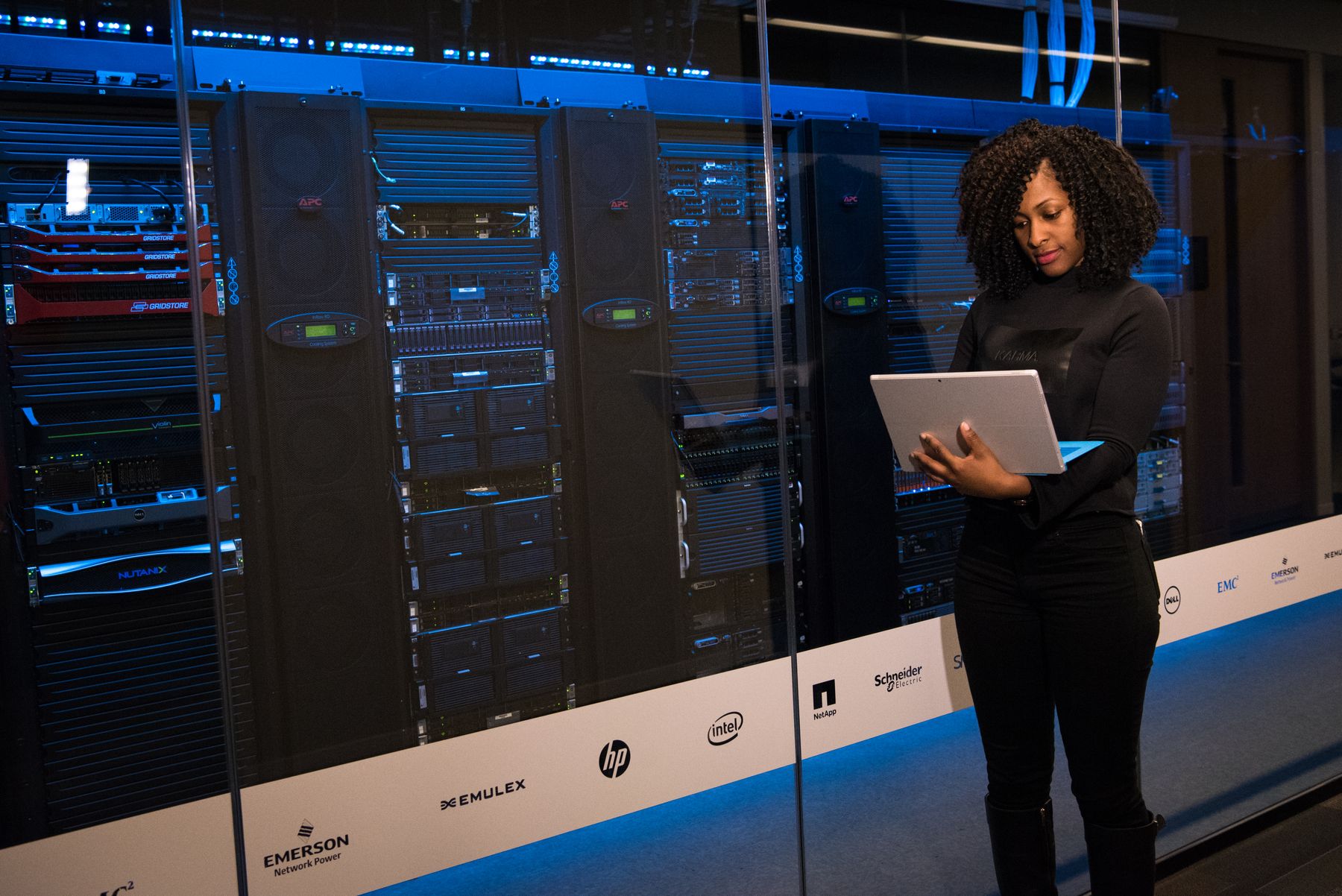 A TecFlax engineer reviewing systems on a tablet in a data centre